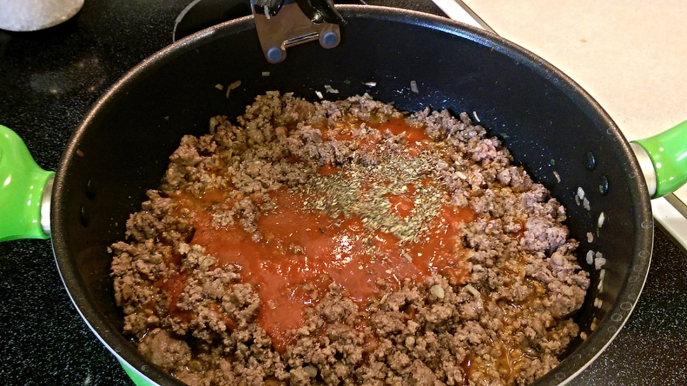 Adding the sauce and seasonings.