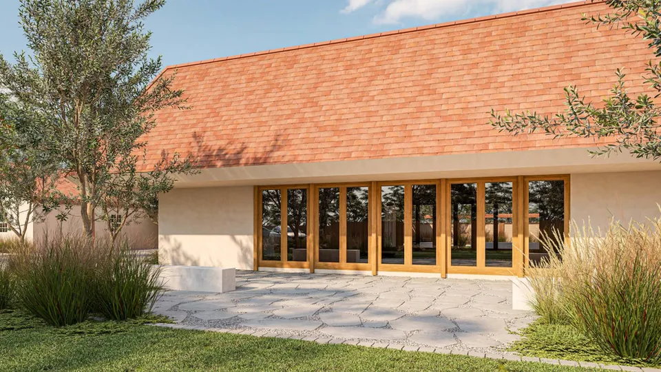 Rendering of the sanctuary side of the UAMEZ campus with new wood-framed glass doors and a flagstone patio