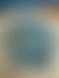 a paint brush dipped in a palette of sea blue and green paints