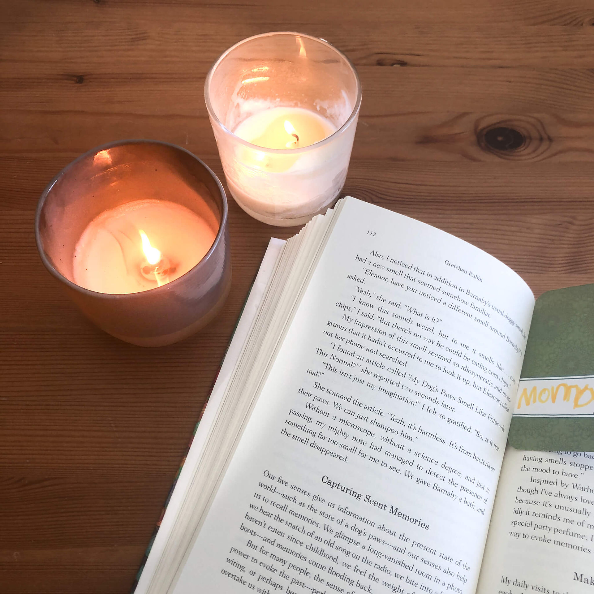 open book next to scented candles
