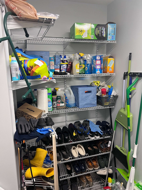 mess of shoes and cleaning supplies in mudroom