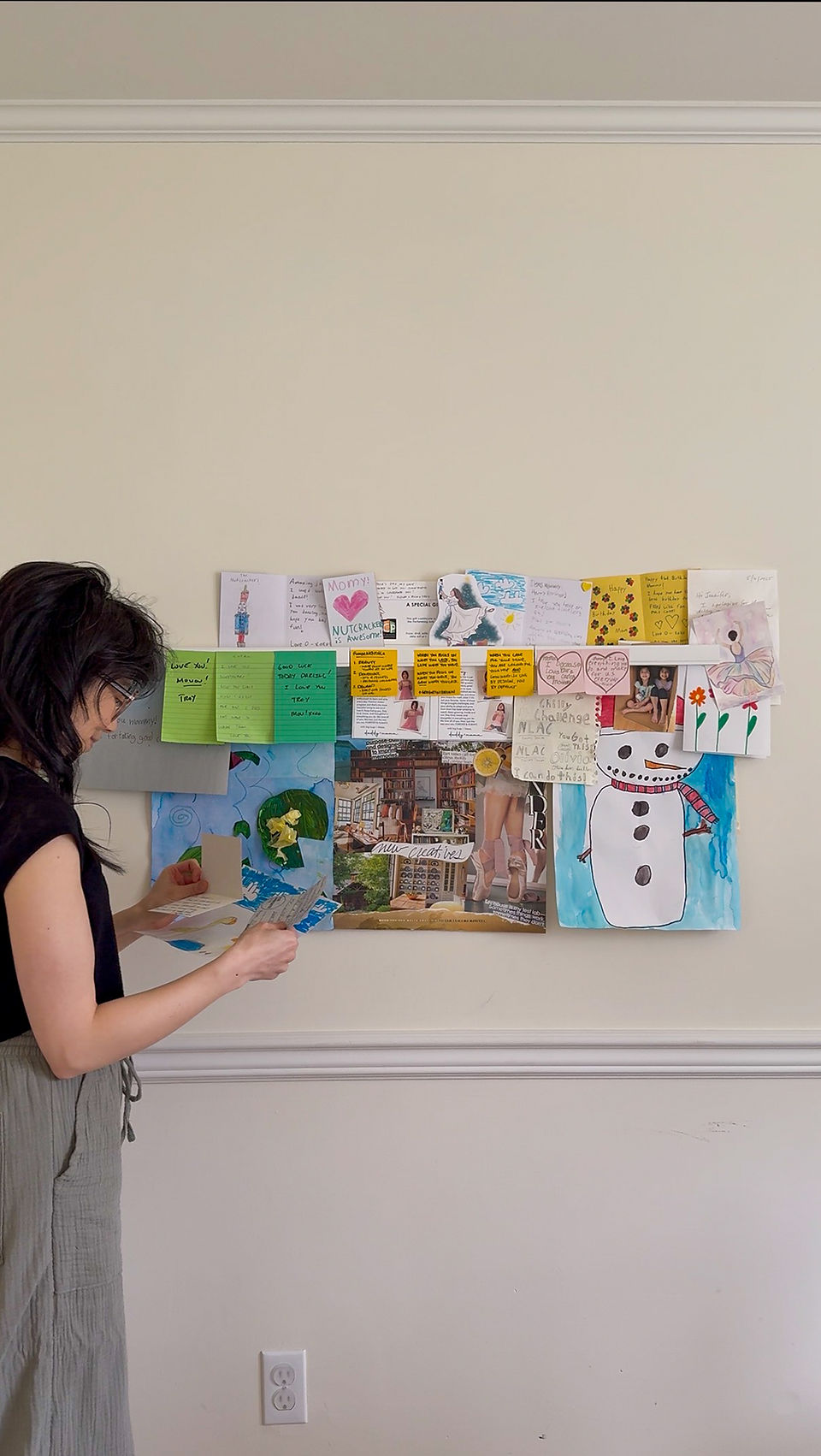 Jennifer looking at card from her gallery rail