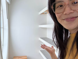 Jennifer gesturing to DIY closet shelves