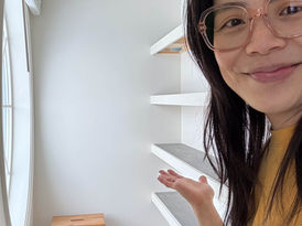 Jennifer gesturing to DIY closet shelves