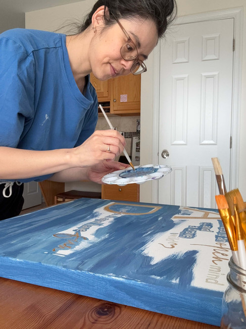 Jennifer dipping paint brush into paint palette