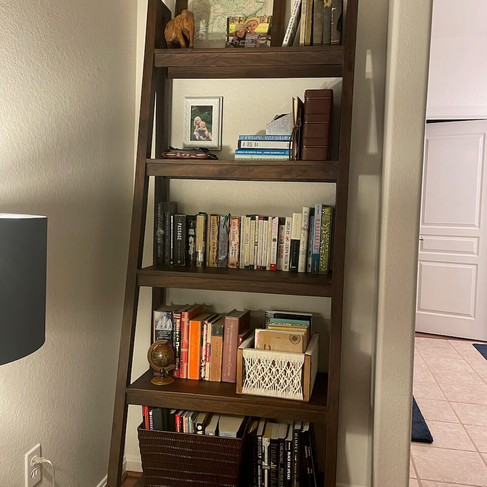 ladder bookcase displaying favorite books and sentimental pieces