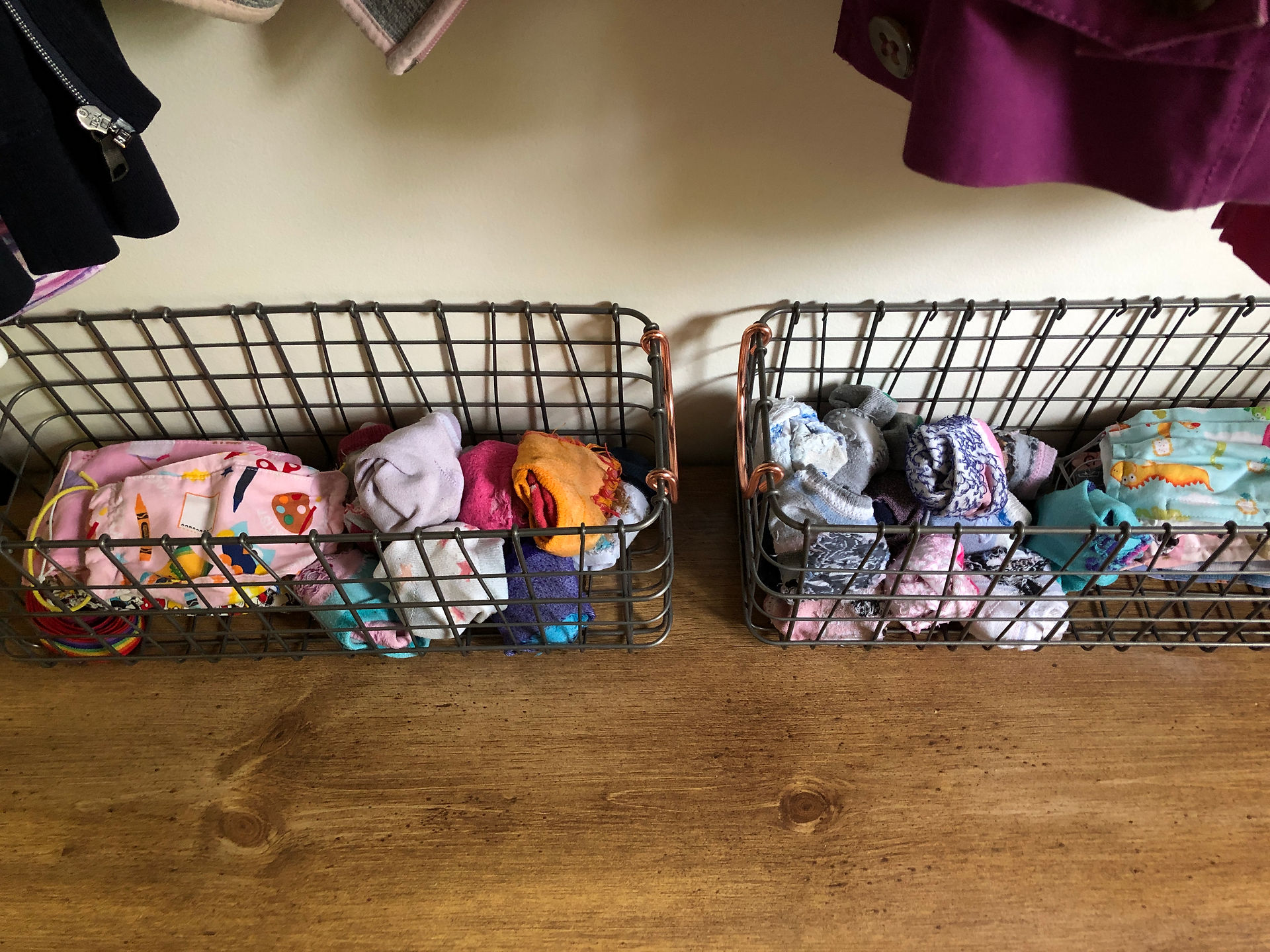 Kid socks and masks stored in baskets in the mudroom makes getting out the door easy