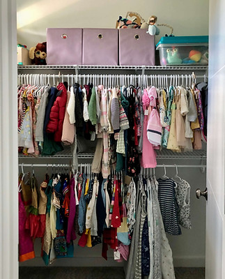 after-mauve toy bins on shelf above neatly hung kids clothes organized by age.jpg