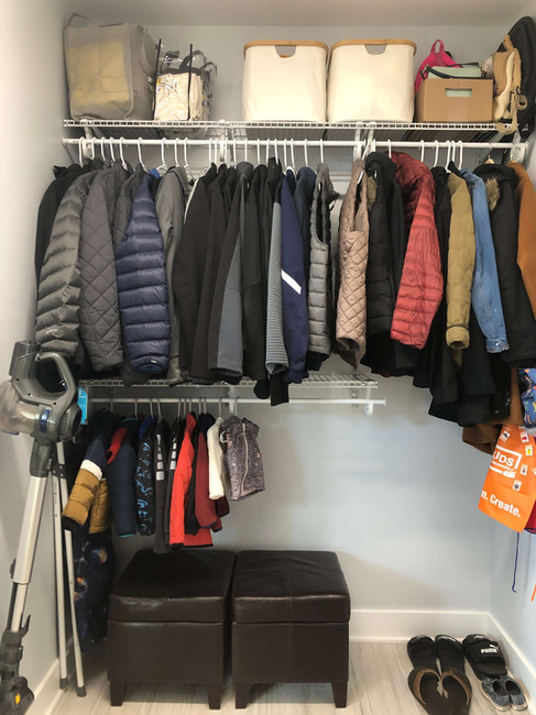 coats neatly hung in mudroom
