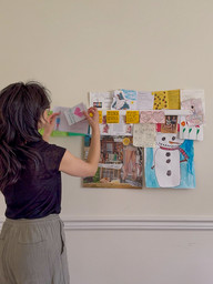 Jennifer taking notes down from her gallery rail