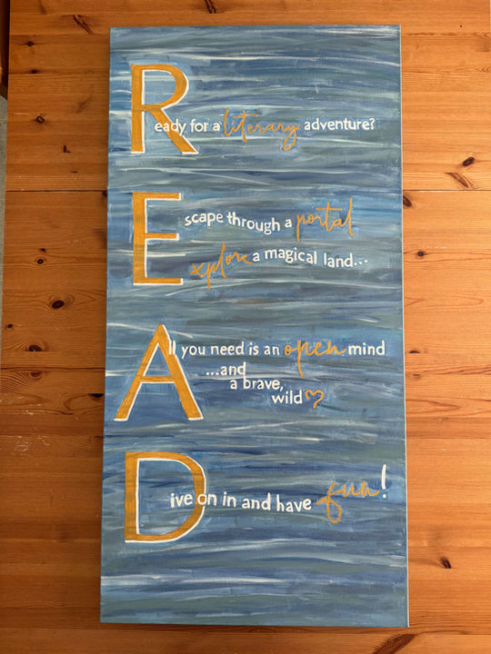 sea blue-green painted canvas with gold and white letters