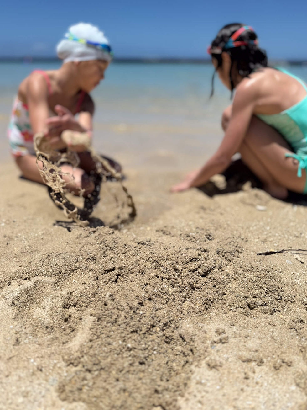 girls playing in the sand on a beach