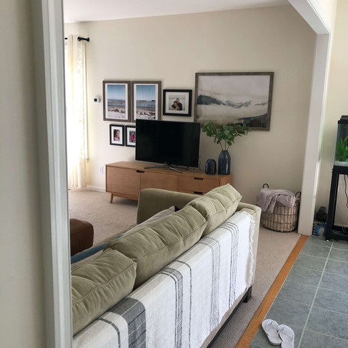 view of gallery wall as you walk into the open concept kitchen eating family space