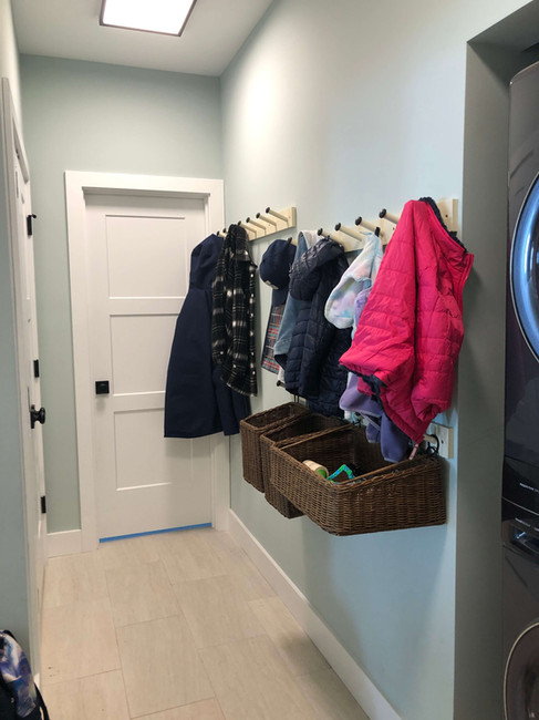 coats neatly hung on wall hooks