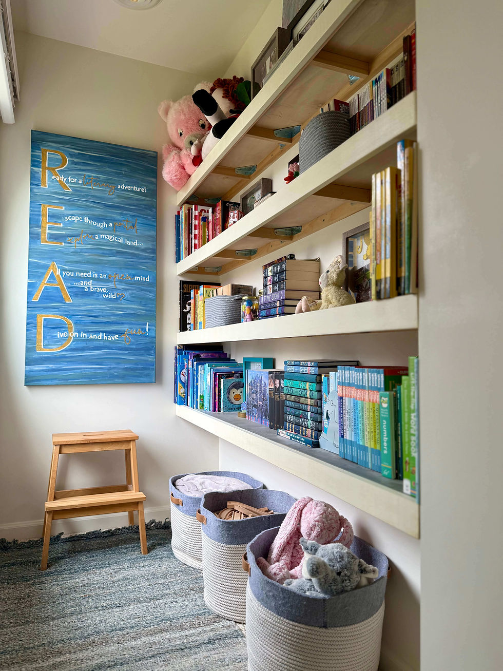 a walk-in closet library with shelves of books and toys