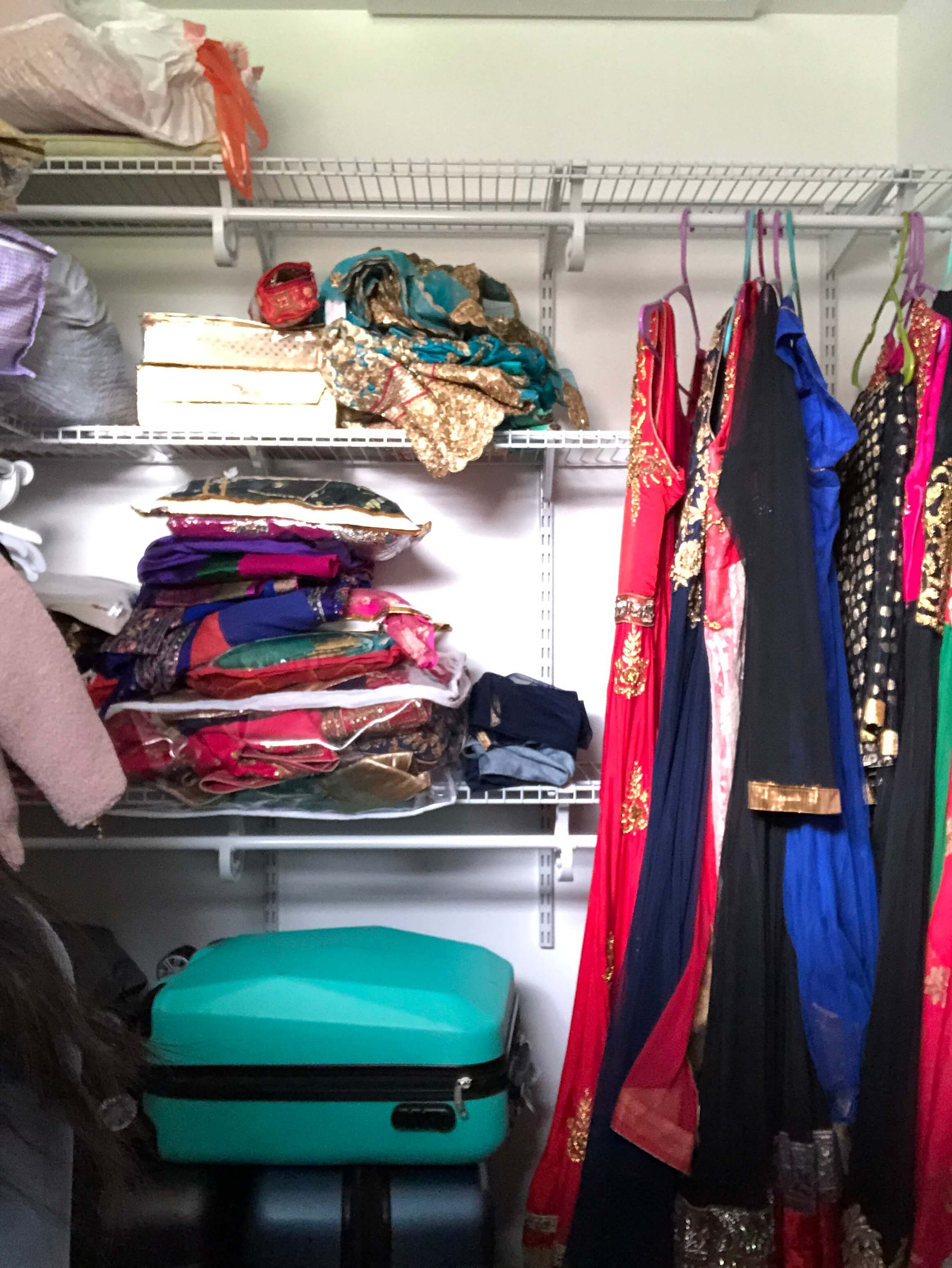 closet full of formal Indian garments and luggage