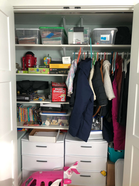 messy playroom closet of clothes toys and books