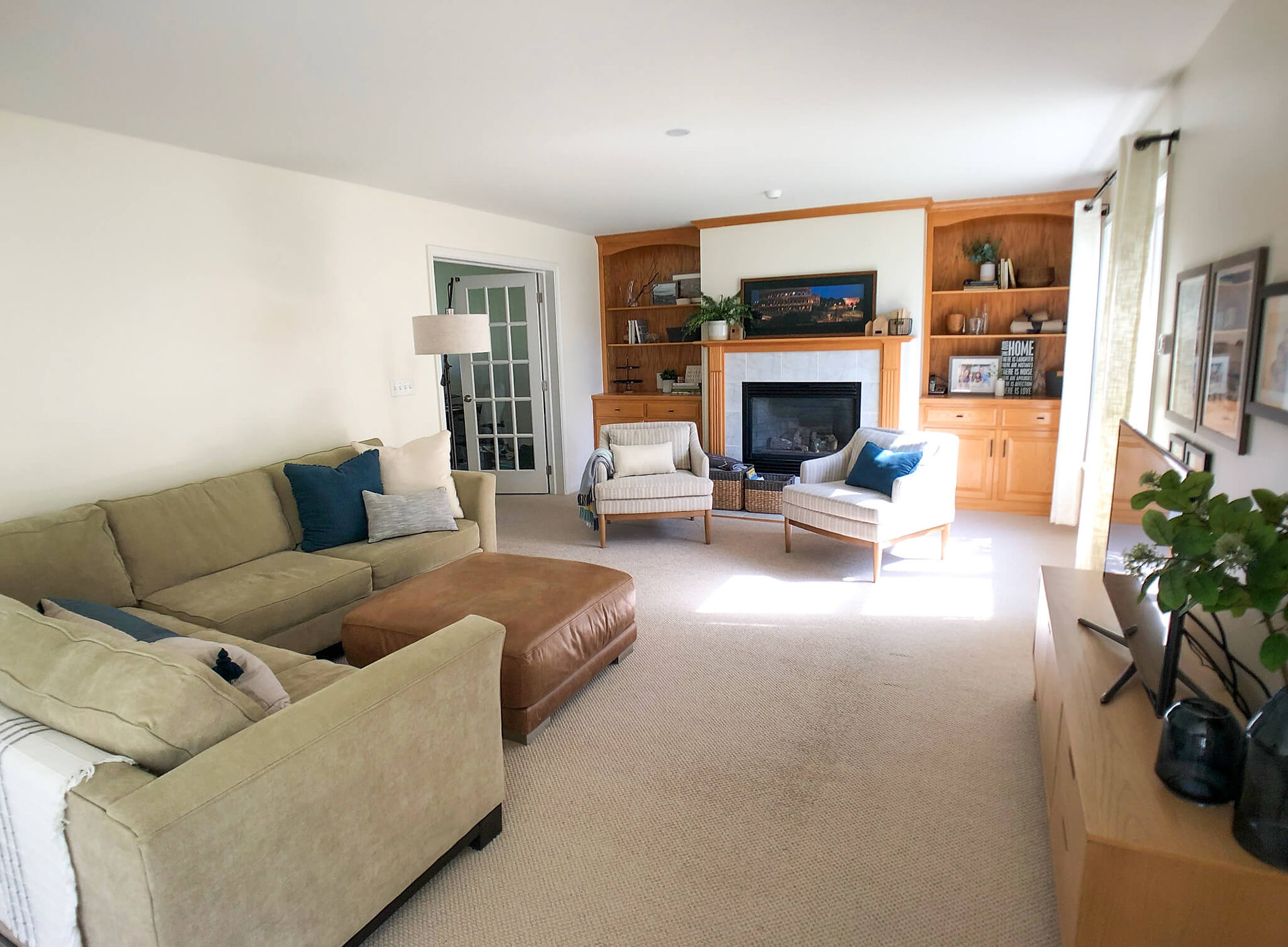 cozy family room personalized with curated artwork, photographs, and decor