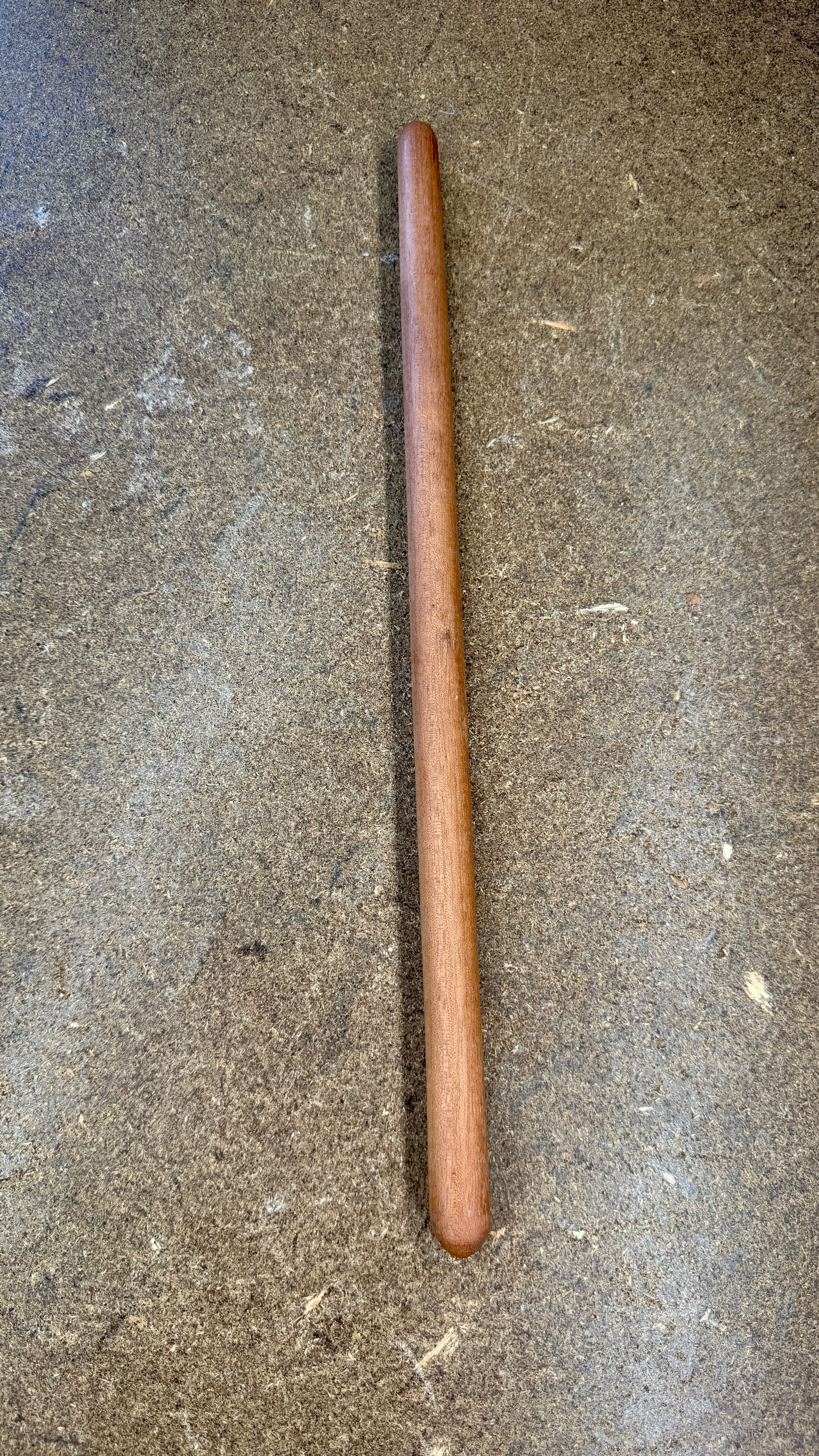 brown conical repique stick on a grey background