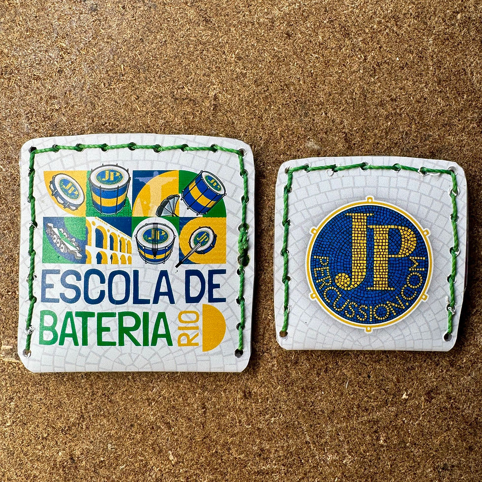 Two different sizes of caixa de fósforo, samba shaker with JP percussion and escola de bateria rio logos.