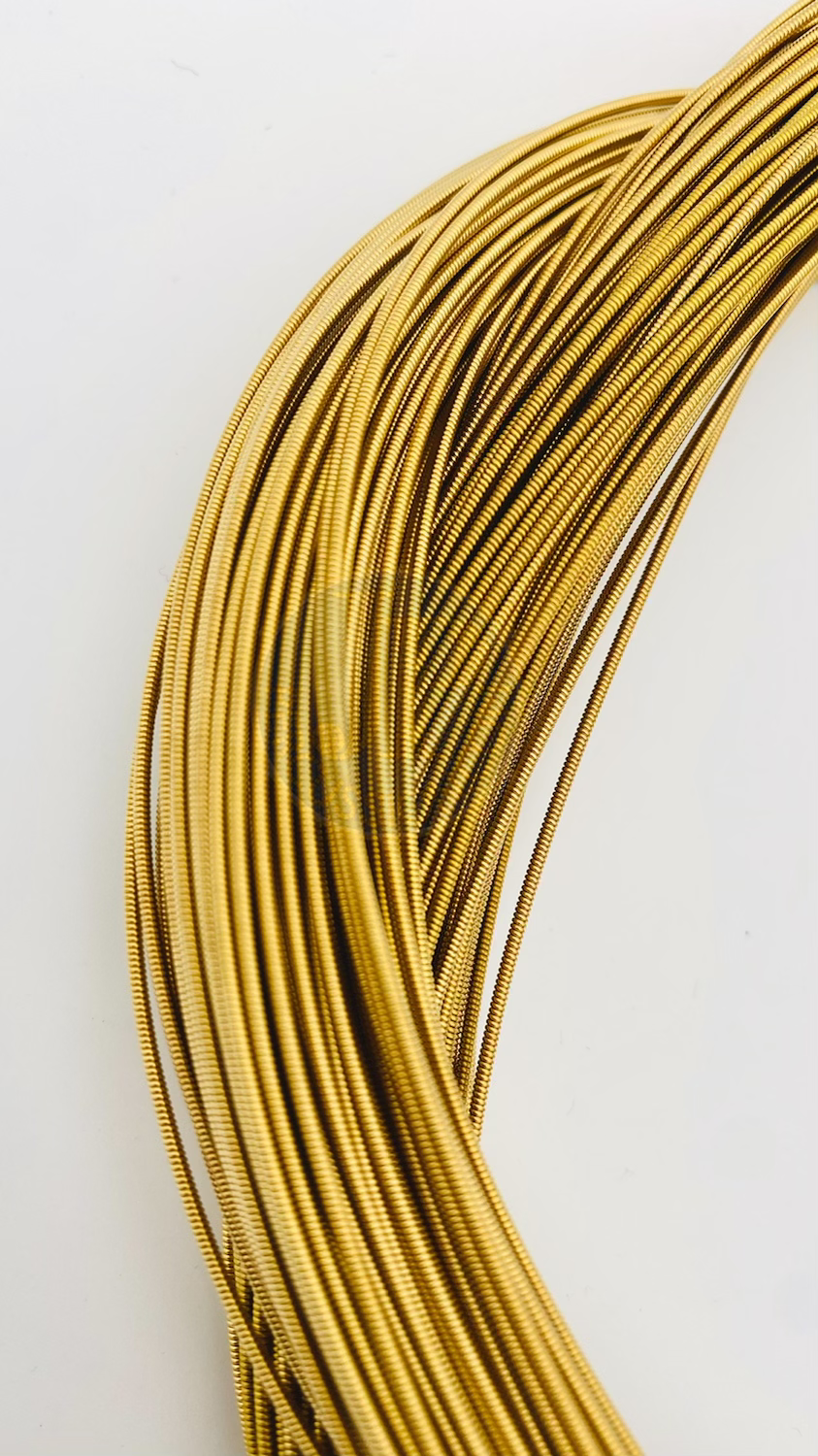 Thumbnail: Top down view on a section of a bundle of samba caixa snare wire or bordão on a white background.