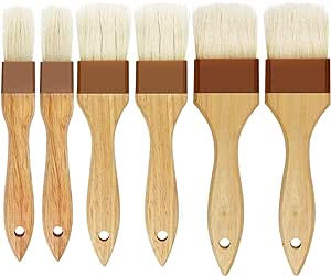 Six natural bristle paintbrushes with wooden handles arranged vertically. Handles have holes for hanging and brown bristle holders.