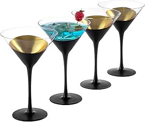 Four black-stemmed martini glasses, three empty, one with blue liquid and a red berry. Gold interiors, on a white background. Elegant vibe.