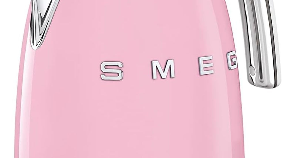 Pink SMEG kettle with chrome accents, featuring a modern, rounded design. The brand name is embossed on the side.