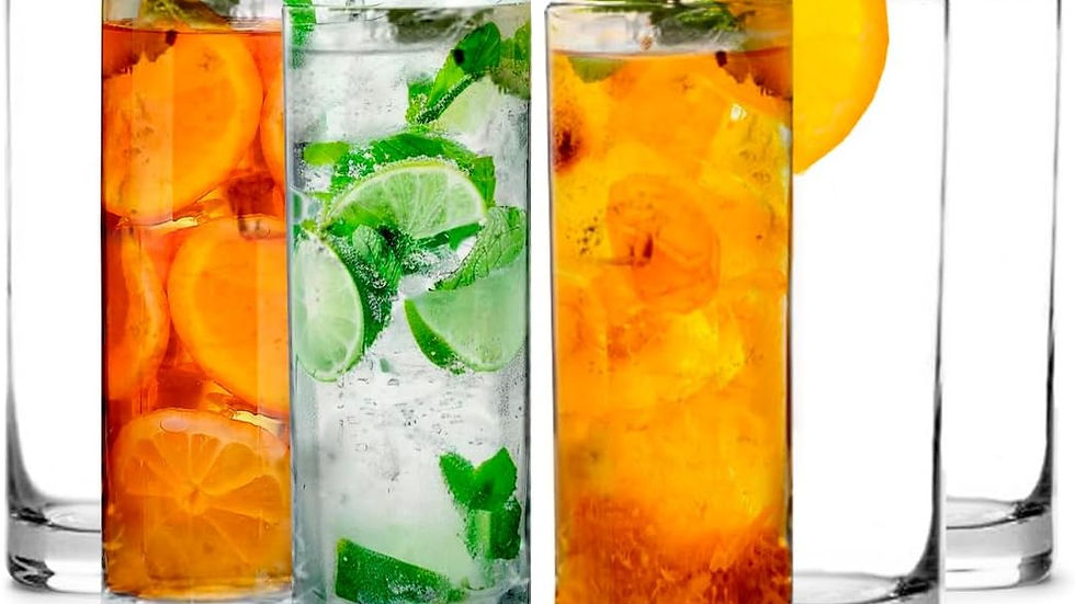 Three colorful drinks in glasses: orange with sliced citrus, clear with lime and mint, and orange with a slice. Clear glasses in the background.