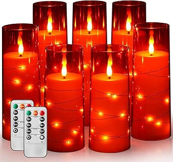 Red LED candles with glowing lights are displayed in glass holders. Two remote controls are in front. The scene is warm and cozy.