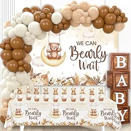 Bear-themed baby shower setup with balloon arch, teddy bear backdrop, and table reading We Can Bearly Wait and BABY blocks.
