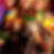 Smiling group holding colorful cocktails with fruit and umbrellas. Bright, festive atmosphere. Focus on drinks, party mood.