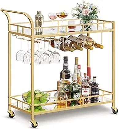 Gold bar cart on wheels with wine bottles, hanging glasses, limes, and a flower arrangement on top.