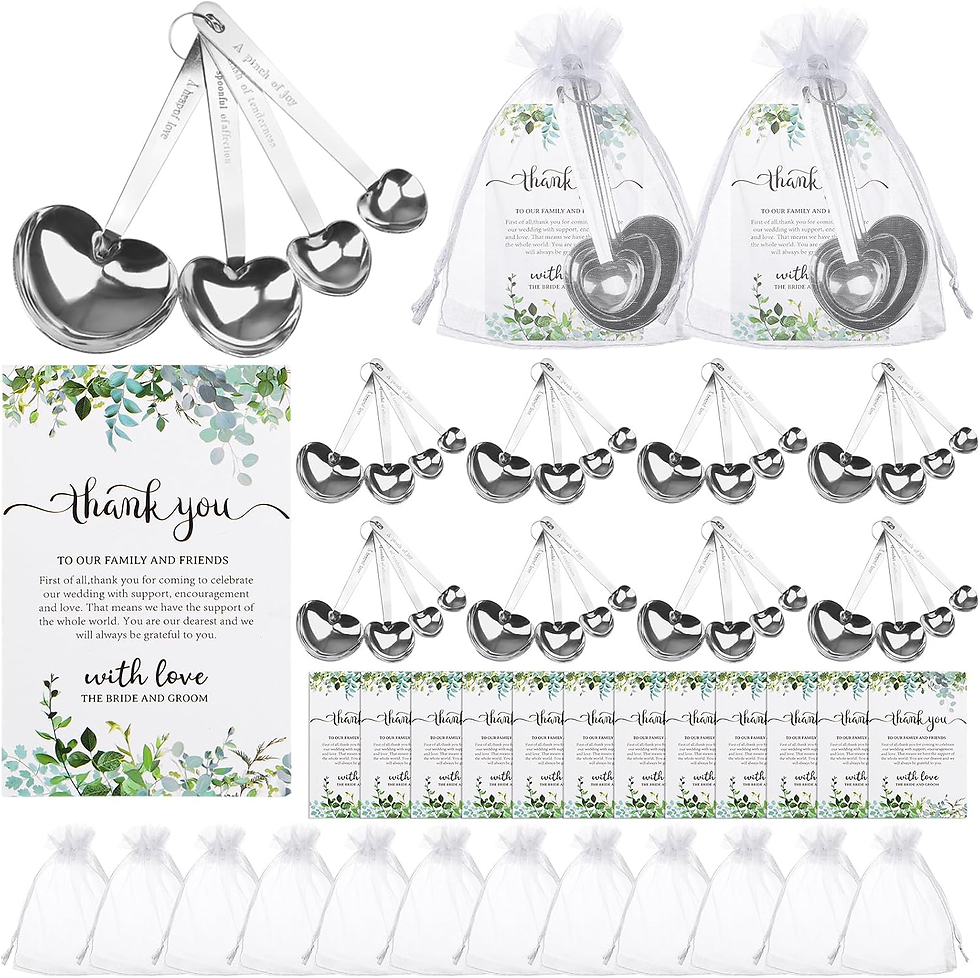 Wedding favor set with heart-shaped spoons, thank you cards, and sheer gift bags on a white background