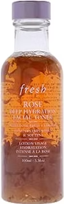 Pink-labeled clear bottle of fresh Rose Deep Hydration facial toner with amber liquid on a white background.