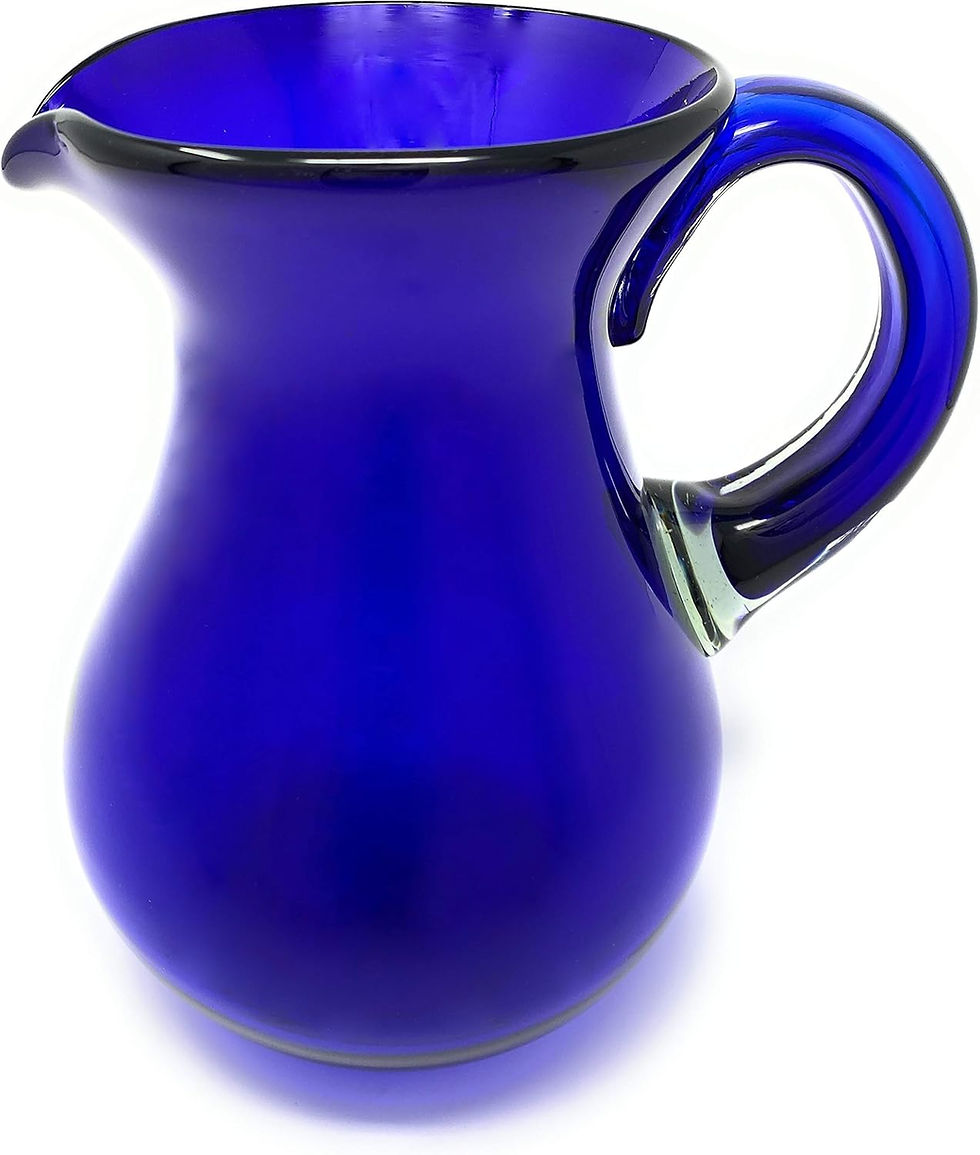 Blue glass pitcher with a wide spout and handle on a white background. The vibrant cobalt color stands out.