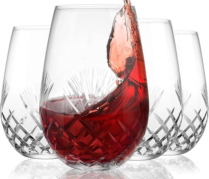 Close-up of red wine splashing in a crystal glass with etched patterns. Two empty glasses in the background. Elegant and dynamic mood.