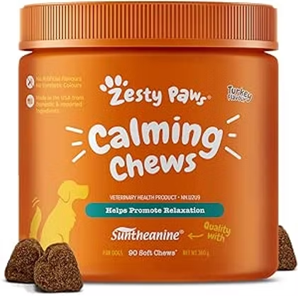 Orange jar of Zesty Paws Calming Chews for dogs, with soft chew pieces and label text promoting relaxation.