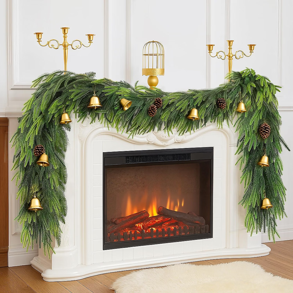 White fireplace decorated with evergreen garland, gold bells, pinecones and candelabras, with a glowing electric fire.