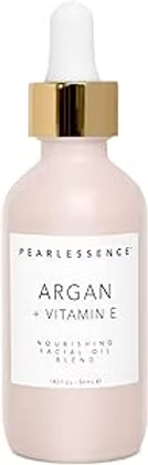 Pearlessence Argan + Vitamin E soothing facial oil serum in a pale pink bottle with gold dropper cap on white background.