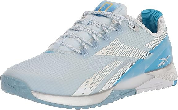 Light blue and white athletic shoe with a grid pattern, blue accents, and a textured sole, set against a plain white background.