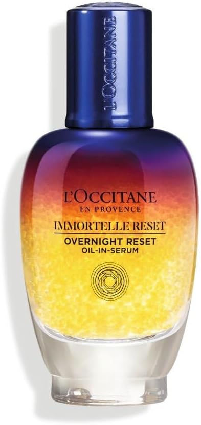 Gradient bottle of L'Occitane Immortelle Reset, featuring blue to yellow ombre design. Labeled "Overnight Reset Oil-in-Serum."