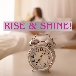 Silver alarm clock with "RISE & SHINE!" text overlay. Blurred figure in a cozy, beige room in the background. Warm, morning ambiance.
