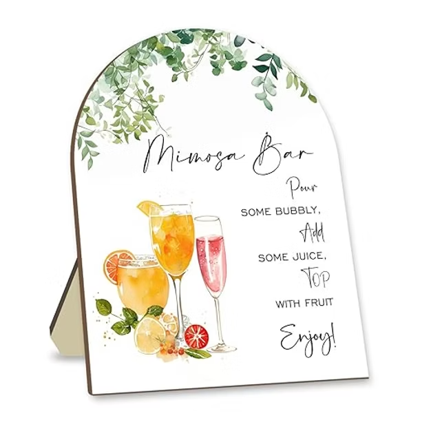Arched white Mimosa Bar sign with leafy greenery and watercolor drinks; text says Pour bubbly, add juice, top with fruit, enjoy!