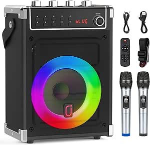 Black speaker with LED ring, two microphones, remote, cables; text "bLUE" displayed. Colorful, vibrant setup for events.