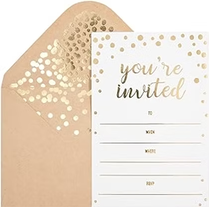 Gold polka dot invitation card in a tan envelope, with you’re invited and blank lines for when, where, and RSVP.