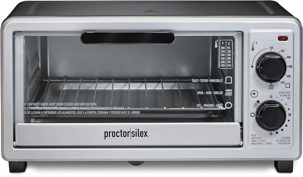 Silver toaster oven with glass door and two control knobs. "Proctor Silex" logo on front. Visible temperature and function settings.