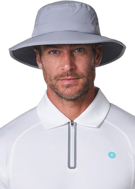 Portrait of a man in a gray wide-brim sun hat and white zip-collar shirt on a white background, looking calm and serious