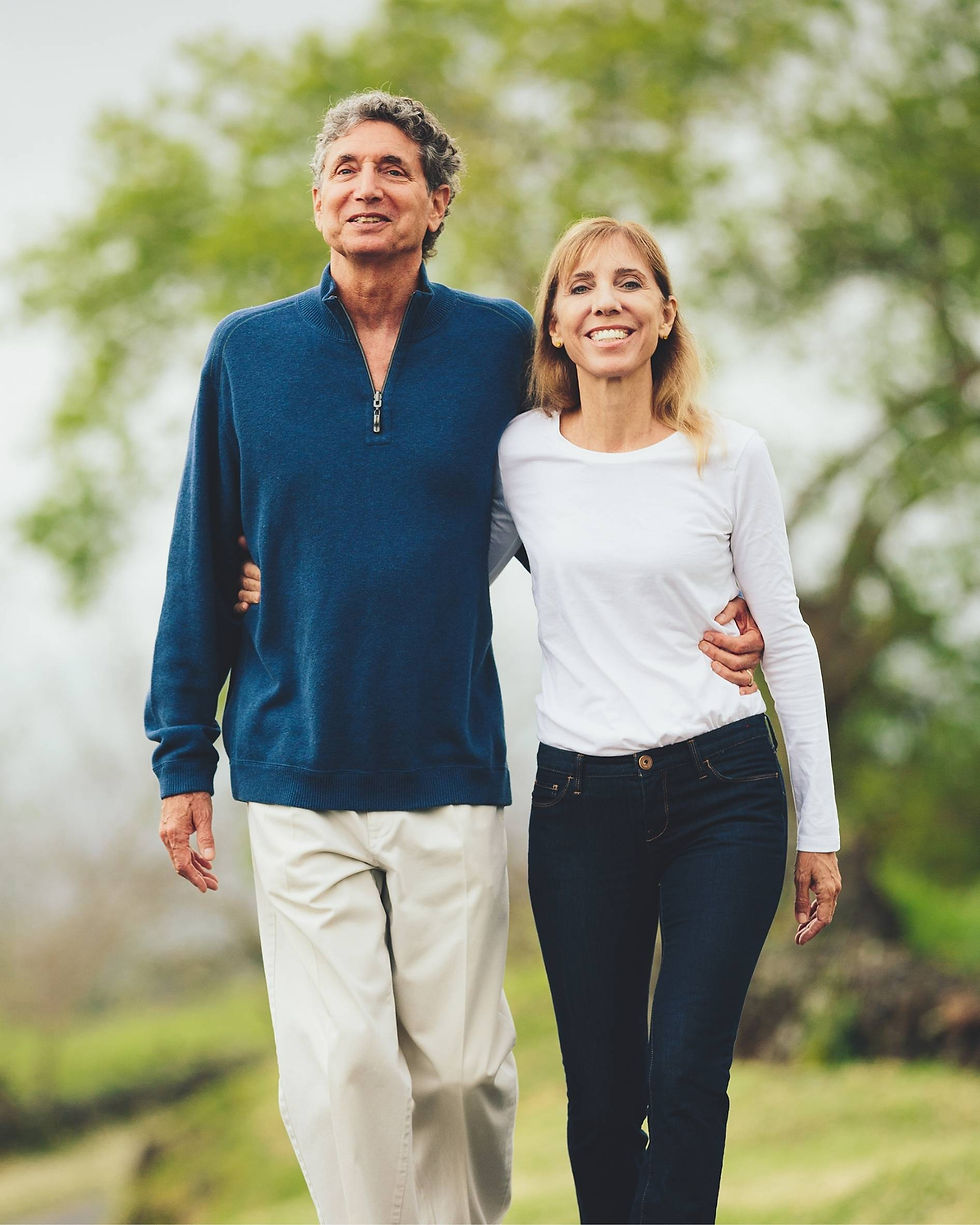couple-smiling-walking-on-sunny-outdoor-walking-path.jpg