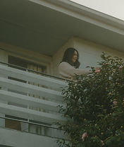 Photographer picking flowers on balcony